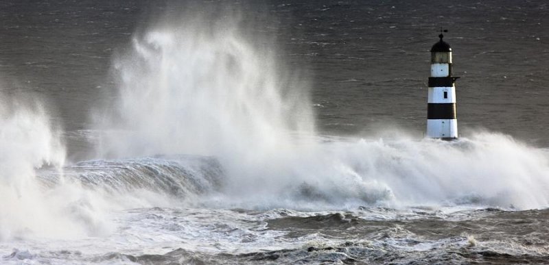 Waves crashing on lighthouses