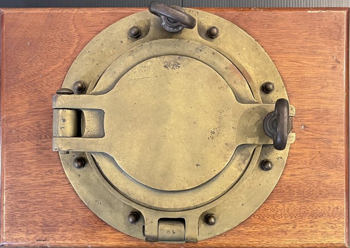 Oblò in ottone su tavola di mogano